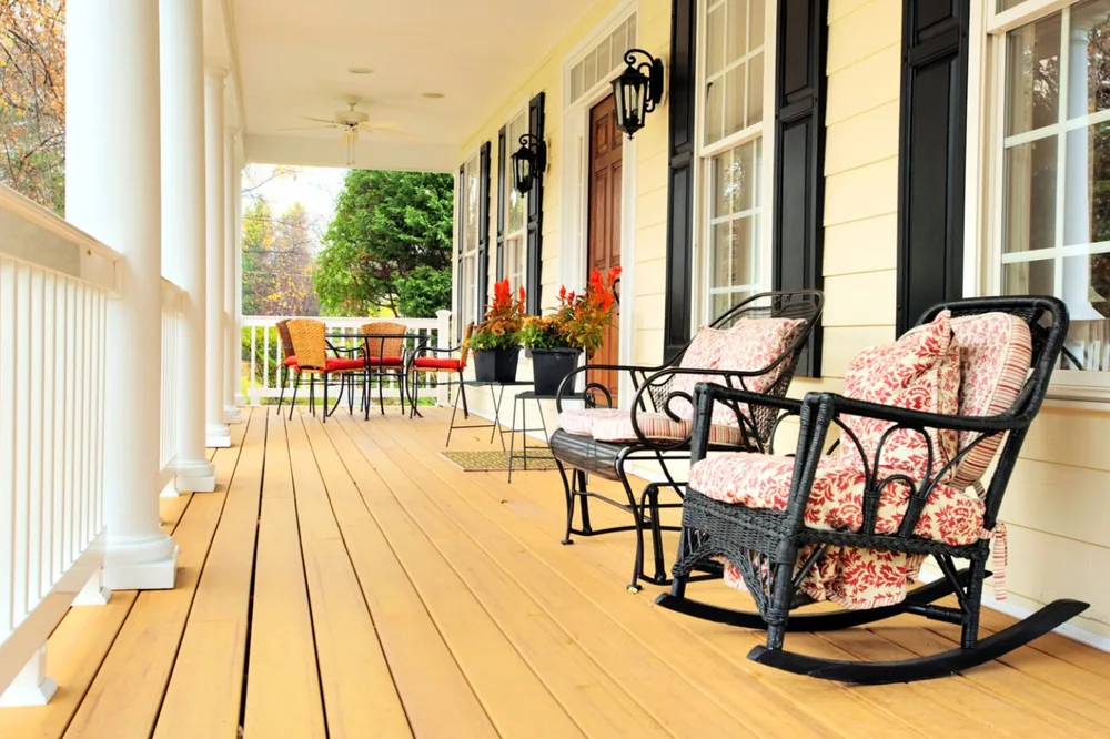 Covered front porch with rocking chairs and white railing NC Foothills — The Foothills Deck Company