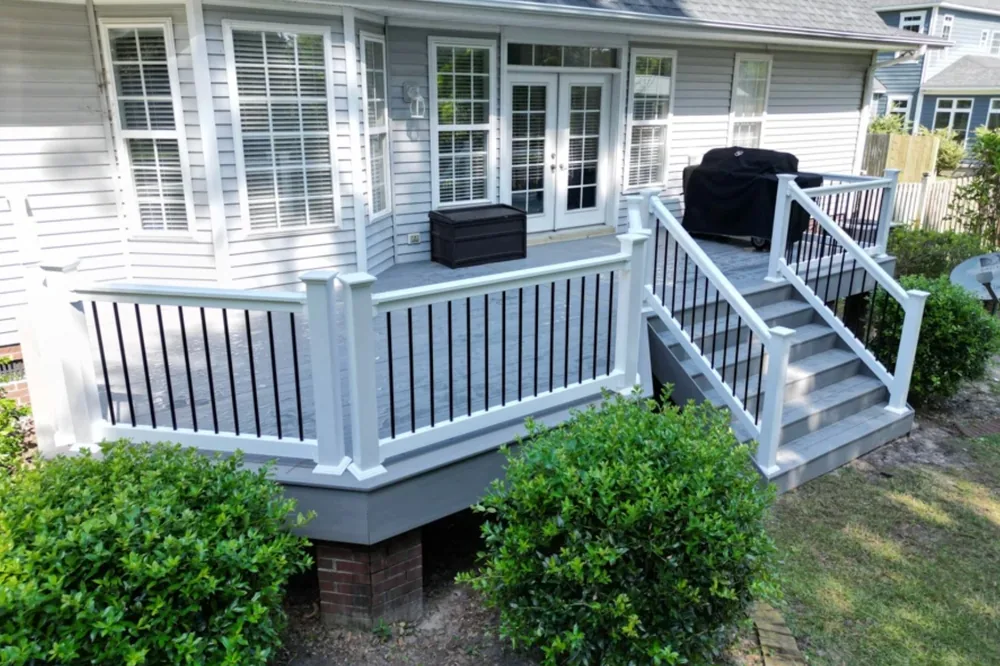 Gray composite deck with white railing and outdoor dining area NC Foothills — The Foothills Deck Company