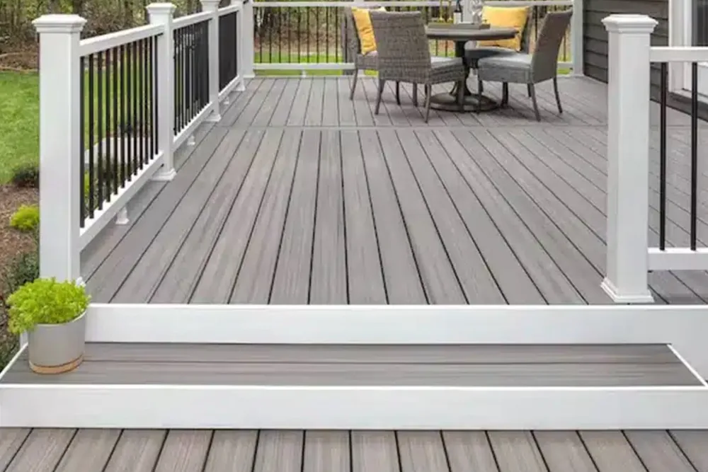Gray composite deck with white railing and steps NC Foothills — The Foothills Deck Company