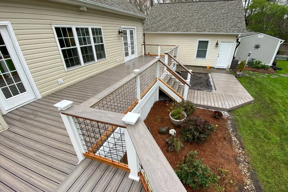 Multi-level composite deck with wood-topped wire panel railing NC Foothills — The Foothills Deck Company
